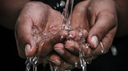 Water running through cupped hands